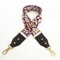 Detail of leopard print bag strap with gold rivets and metallic lobster clasps - Purple Spots