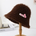 Close-up of brown fuzzy bucket hat with a cute pink bow and sweet design details - Coffee