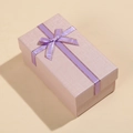 Macro detail of purple rectangular gift box with fine grid texture and golden bow - 14x8x6cm / Purple