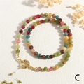 Detailed shot of multi-color gemstone beads necklace with a gold clasp on white background - Spring Clasp Style (MNE0138)