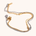Dubbellaagse gouden en zilveren slangenarmband met knoopdetail en verstelbare karabijnsluiting - Tweekleurig Goud Zilver