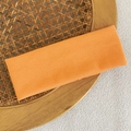 Elastic orange ribbed knit headband for makeup and sports on a woven tray - Orange