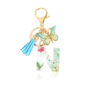 Letter N resin keychain with red dried flowers, green butterfly, and blue tassel - Letter N
