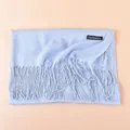 Detail of light blue cashmere scarf with elegant tassels and stitched logo tag - Light Blue