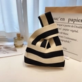 Knitted wrist bag featuring classic black and white wide stripes with a soft texture - Black & Beige Stripes