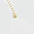Minimalist gold necklace with a round pendant featuring a crystal letter L design - Letter L