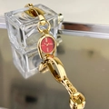 Close-up of a vintage-style gold horsebit bracelet watch with a striking red dial face - Gold Case Red Dial