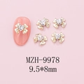 Macro view of golden bow nail art charms with heart crystals, sized 9.5x8mm - Gold Bow + Clear Heart Stone (9978)