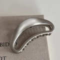 Macro shot of matte silver alloy crescent hair claw clip with hollow metal structure - Frosted Matte / Matte Silver