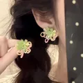 Detail of multi-layered flower earrings with matte green petals and macaron color frames - 13# Green Pink 3D Flower Earrings