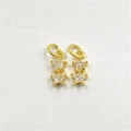 Detailed macro view of gold-plated double star pendants with clear zircon stones - Clear
