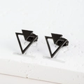 Macro detail of geometric matte black triangle earrings on a textured stone stand - Triangle / Black