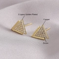 Golden triangle stud earrings in zircon and triple-layer plated brass on silk background - Triangle Style
