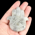 Hamsa Hand figurine carved from natural light-colored crystal with dark inclusions - Labradorite