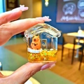 Detail of Capybara-themed liquid sand earphone case with golden flowing glitters - Wooden Fish Capybara House