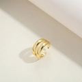 Dettaglio dell'anello a doppio strato placcato oro 14K su superficie crema - Stile a doppio strato / Oro