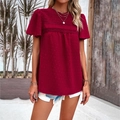 Women's red short-sleeve top with lace trim and polka dot pattern worn with denim shorts - Burgundy
