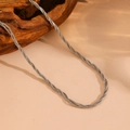 Detailed view of silver multi-strand twisted snake chain on a natural wood block background - Q809-2 Round 1 Square Steel Braided Necklace