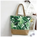 Canvas and jute tote bag featuring green leaf patterns and natural jute handles - Light Green Wide Leaf