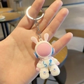 Close-up of cute cartoon astronaut rabbit keychain in pink and blue soft silicone - Pink Keyring Space Rabbit