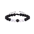 Detailed macro view of 8mm black lava stone and white turquoise braided adjustable bracelet - White Turquoise + Lava Braided