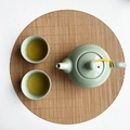 Celadon ceramic tea set with ice-cracked glaze on a round bamboo mat - Carbonized Round 25cm