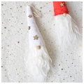 Detail of Christmas gnome ornaments with white and red knit hats and golden star sequins - White