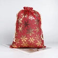 Red Christmas drawstring burlap gift bag with gold snowflake pattern and white rope closure - Red Christmas Snowflake