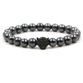 Macro detail of natural stone beaded bracelet featuring a black leopard head with green eyes - Black Leopard