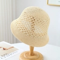 Detailed view of hollow crochet woven pattern on a beige straw bucket sun hat - M(56-58cm) / Beige