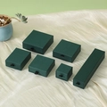 Dark green drawer jewelry boxes with black ribbon handles on silk background - Dark Green
