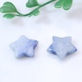 Pair of blue natural stone star pendants with organic texture on white background - Blue Aventurine