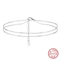 Detail view of S925 sterling silver triple layer anklet with polished cylinder charms - 925 Silver / Platinum