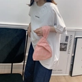 Close-up of pink checkered knit knot bag worn on wrist for a minimalist lifestyle look - Pink Grid