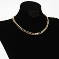 Gold Cuban link chain necklace with a central round zircon stone on a black display stand - Gold Cuban Link Style (D791)
