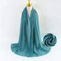 Teal green pearl chiffon scarf draped on model with a textured fabric detail view - Turquoise Green