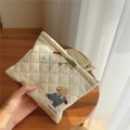 Detailed close-up of quilted cotton makeup bag with cute bear and rabbit prints - Big Bear
