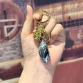Iridescent conch shell keychain in dark gradient plating with gold bell and ring - Small Black Conch