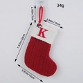Red knitted Christmas stocking with embroidered letter K and Santa hat detail - Letter K Style