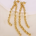 Elegant gold titanium steel tassel earrings with oval beads on a white textured background - Gold