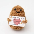 Positive potato crochet toy in brown holding a German encouragement card on white backdrop - Dark Brown German Potato