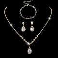 Three-piece gold jewelry set with teardrop crystals on a black background - 463+785 3-Piece Set / Gold