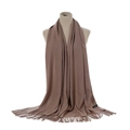 Detail of brown cashmere scarf with long fringe tassels on a mannequin torso - Khaki