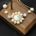 Elegant natural pearl bracelet with blue gemstones and a floral mother of pearl charm - Cat Eye Shell Sunflower Bracelet