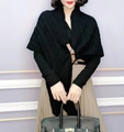 Chic black knitted shawl poncho featuring a brown leather buckle and textured weave - Triangle Style / Black