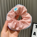 Pink and white checkered scrunchie with blue trim and a small heart label - Small Grid / Pink