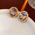 Vintage gold butterfly stud earrings with purple enamel inlay on white ceramic dish - Purple Butterfly Enamel Studs