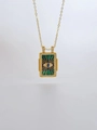 Macro detail of gold tarot card pendant with emerald enamel and evil eye crystal stones - Rectangular Pendant / Green Eyes