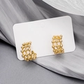 Exquisite gold openwork mesh stud earrings displayed on elegant grey silk background - Gold Hollow Grid Ball Earrings