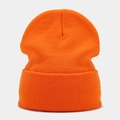 Close-up of bright orange ribbed knit beanie showing high-quality texture and cuff - Orange
